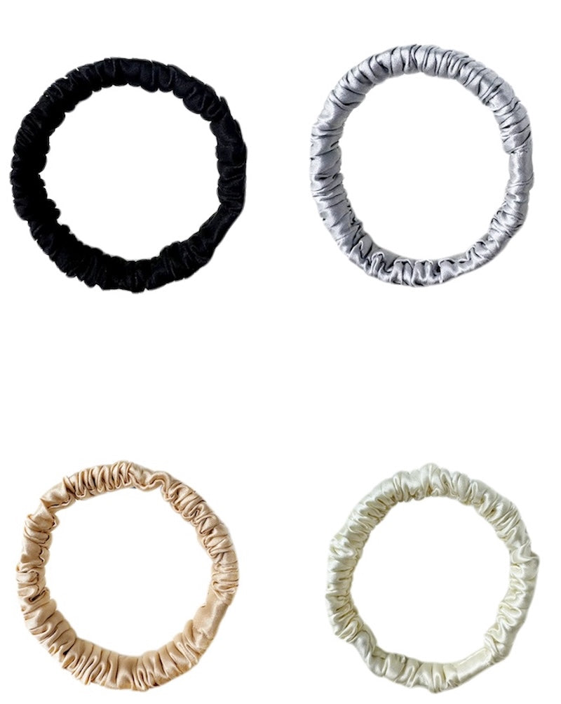 Four hair scrunchies in black, white, beige
