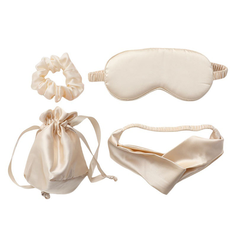 Set of cream-colored sleep mask, headband, scrunchie, and drawstring bag