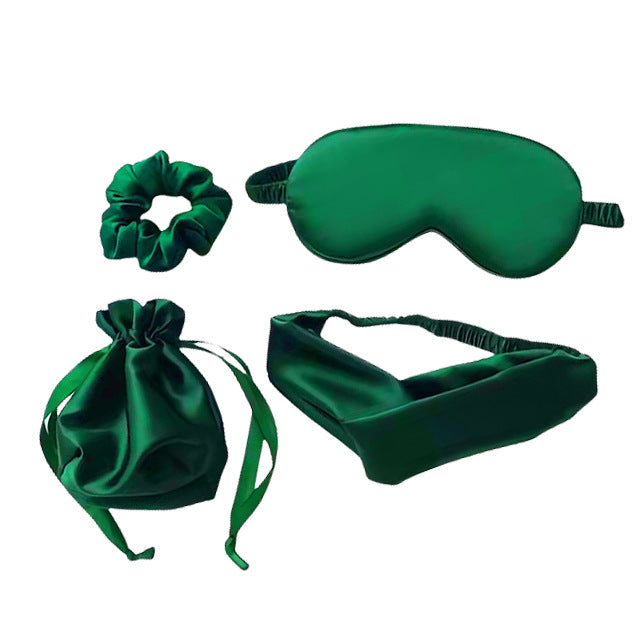 Set of green satin items including a sleep mask, headband, scrunchie
