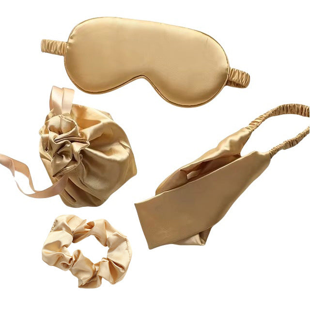 Set of gold satin items including a eye mask, and scrunchie