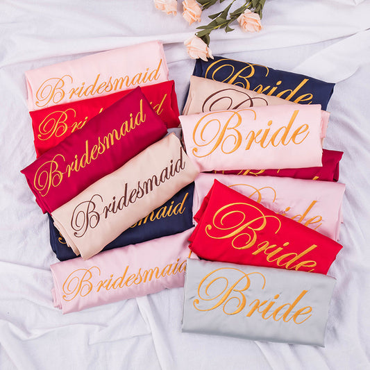 satin robes with 'Bride' and 'Bridesmaid' text