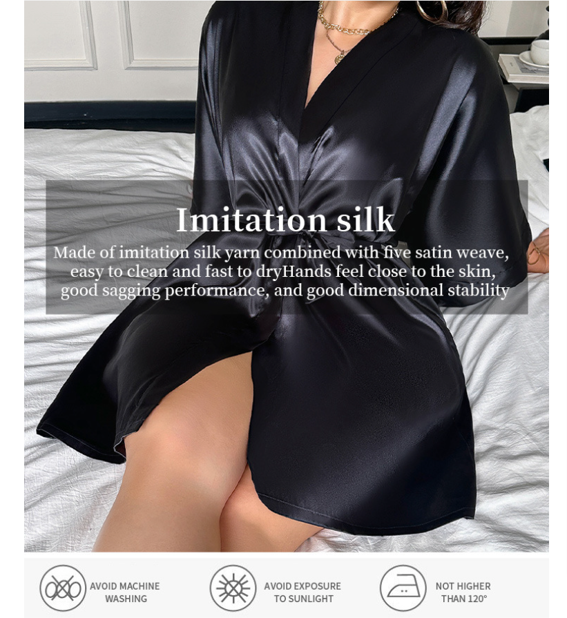 Person wearing a black satin garment on a bed with product details overlay.