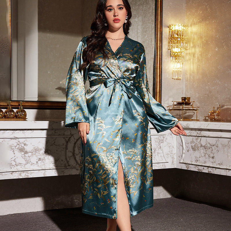 Woman wearing a blue satin robe with floral patterns in a luxurious room.